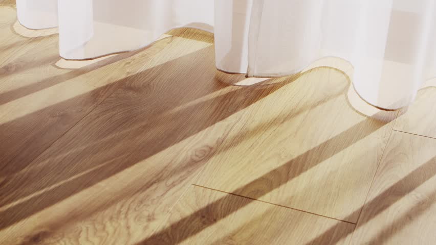 Transparent white curtain tulle moves from the wind from an open window with shadows. Sunny day, the sun's rays sunlight penetrate the room.