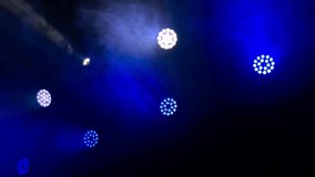 Professional stage lighting equipment with blue and white spotlights flashing through thick smoke, creating a vibrant and dynamic atmosphere for a concert, show, or nightclub performance - Powered by Shutterstock - Get 15% off with code: PIKWIZARD15