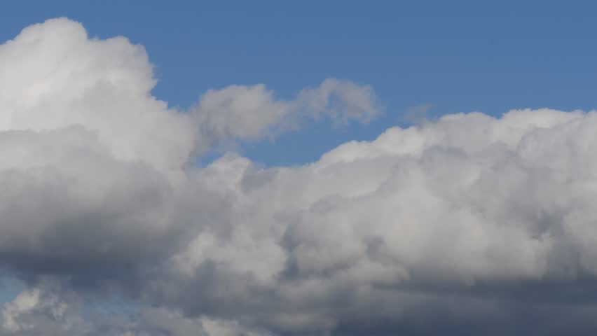 Beautiful White Cumulonimbus Fluffy Clouds Moving on the Sky. Rainy Clouds in a Slideshow on the Sky in a Summer Day.