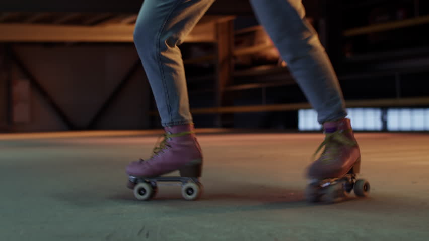 Pink roller skates glide smoothly on parking skate park floor
