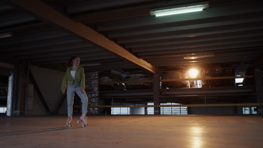 Stylish woman disco dancer skates about indoor skating rink