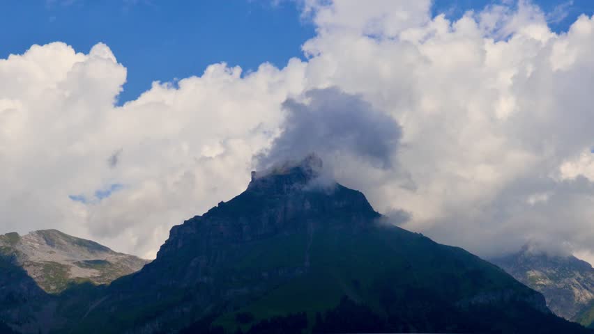 Towering Mountains and Clouds Over Engelberg, Switzerland. Switzerland, August 15, 2025
