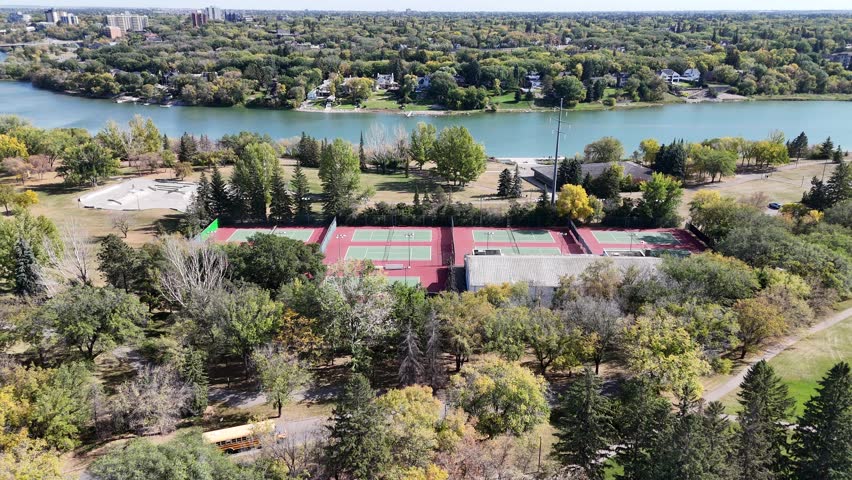 4K aerial view of King George in Saskatoon, showing homes, schools, parks, and its riverside location near the South Saskatchewan River.