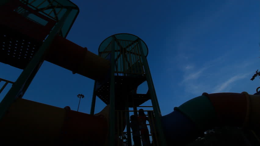 The children enjoy playing in the park at evening.