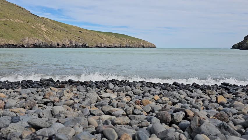 Dynamic waves crash over a rocky shoreline creating a natural soundscape Perfect stock footage for coastal documentaries ambient nature scenes meditation backgrounds travel projects and seascape story