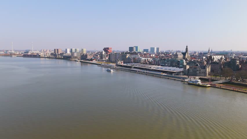 skyline antwerp belgium boats scheldt river historical buildings banks docked harbor scenic urban area infrastructure journey aerial drone shot view