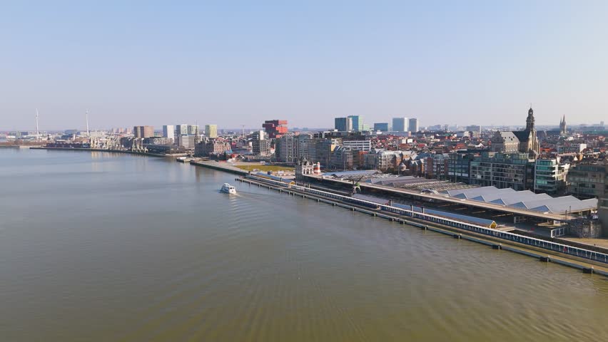 skyline antwerp belgium boats scheldt river historical buildings banks boat traveling water scenic urban area infrastructure journey transportation aerial view