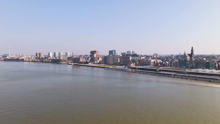 skyline antwerp belgium historical buildings banks boat traveling water colorful city boats scheldt river scenic urban area infrastructure aerial view
