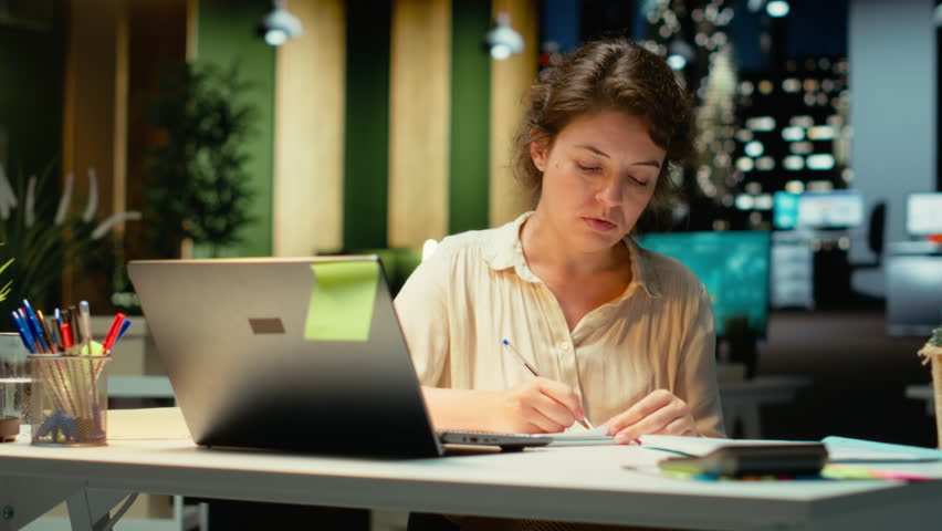 Corporate strategist ripping a paper after writing the wrong idea, restarting her work in rage and crumpling the page sheet, Discontent woman does a typo mistake while transcribing. Camera B.