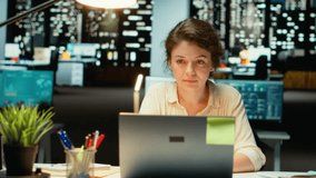 Businesswoman joins an online meeting at night in corporate office, maintaining eye contact with the camera. Manager focused on communication, participating in collaborative dialogue. Camera B. - Powered by Shutterstock - Get 15% off with code: PIKWIZARD15