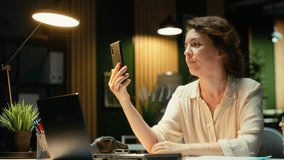 Businesswoman in the office engages in communication during virtual presentation, talking to participants about a productive collaboration. Person working late at night on a video call. Camera B. - Powered by Shutterstock - Get 15% off with code: PIKWIZARD15