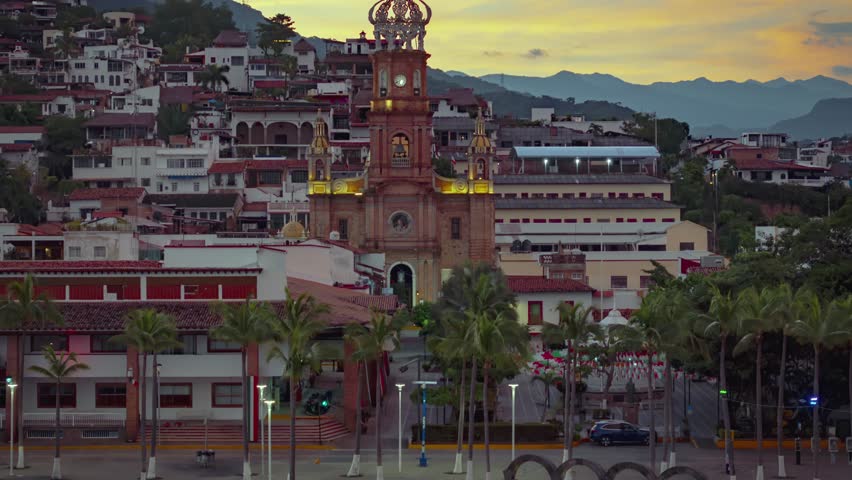 Timelapse of Puerto Vallarta church and boardwalk with moving clouds