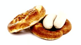 Two pretzels with white sausages on a white background in a close up shot - Powered by Shutterstock - Get 15% off with code: PIKWIZARD15
