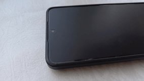 Frosted protective glass is pasted on the phone screen on the table close-up. Repair and maintenance of the phone. - Powered by Shutterstock - Get 15% off with code: PIKWIZARD15