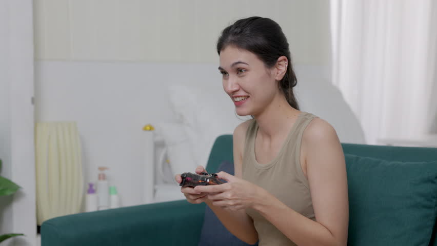 women golding playing joystick video game.