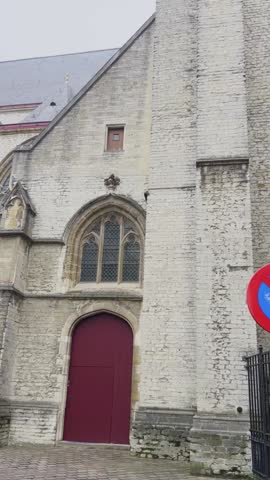 Capture the majestic facade of saint michaels church, a prominent roman catholic church located in the heart of ghent