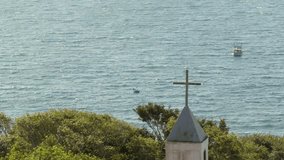 Chapel tower with cross facing the Atlantic Ocean, Nossa Senhora da Imaculada Conceição, Bombinhas, Santa Catarina, Brazil. - Powered by Shutterstock - Get 15% off with code: PIKWIZARD15