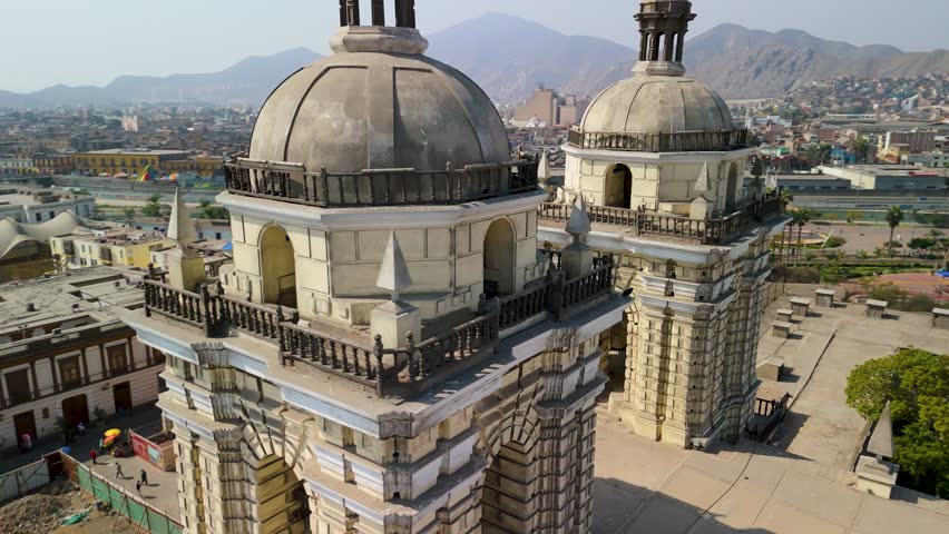 A dramatic close-up aerial parallax shot moves between the twin bell towers of the historic San Francisco Convent, revealing the intricate details of its Spanish colonial architecture