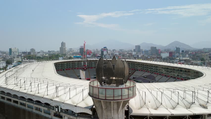 Massive and empty Estadio Nacional of Peru, showcasing the impressive modern architecture of the iconic sports and concert venue without any people or events
- aerial parallax