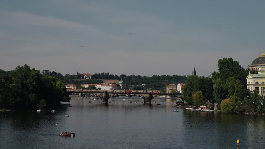 Vltava River with boats and the historic Legion Bridge connecting Prague districts