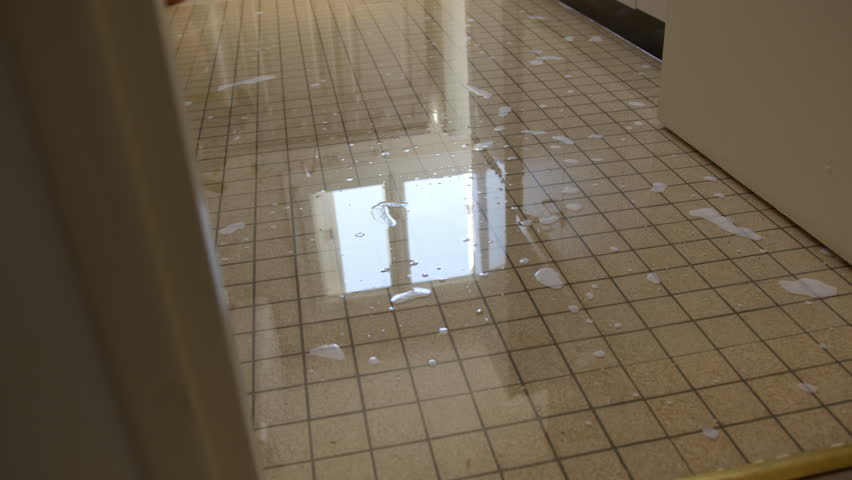 Water And Soap Scattered Across A Tiled Floor - Slippery Tiled Floor With Soap. - closeup shot