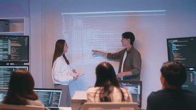 Asian team presents code using a projector during a software development meeting or coding workshop, guiding attendees through problem-solving and programming concepts in an educational setting. - Powered by Shutterstock - Get 15% off with code: PIKWIZARD15