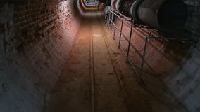 Inside a long straight underground mine tunnel with ventilation pipes, tilt up, The Museum of Mining in Pernik, Bulgaria - Powered by Shutterstock - Get 15% off with code: PIKWIZARD15