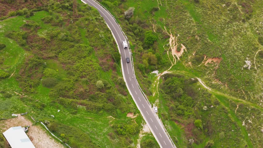 Scenic Albania road winding through lush green landscape and hills