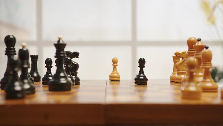 People playing chess. Game of chess on wooden chessboard.