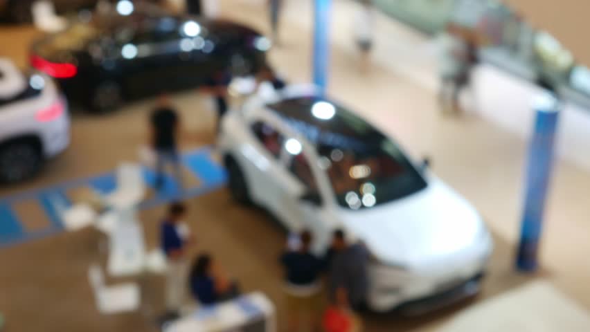 Time Lapse Blurred Car Exhibition in Shopping Mall - Defocused Auto Show Display with Bokeh Effect in Modern Showroom