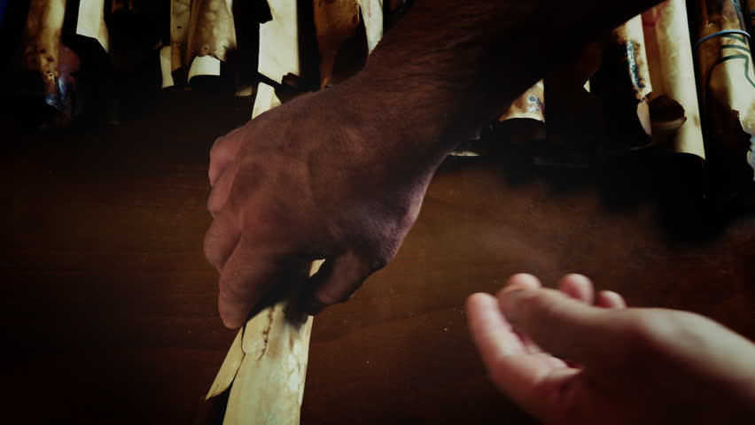 Man Opens Ancient Scroll Parchment a Pentagram Symbol Drawn on It