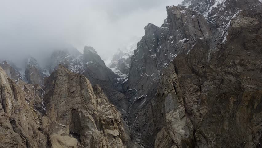 Aerial view of the Karakoram Range in Pakistan, capturing the majestic snow-capped peaks and rugged terrain