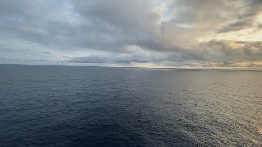 Beautiful Seascape from the Middle of the Ocean with Clouds. A stunning view from the middle of the calm ocean, with peaceful waters and a cloudy sky. A perfect natural landscape, ideal for tranquil 