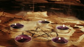 Scary Mystic Pentagram Symbol on an Old Parchment and Candles in Smoke - Powered by Shutterstock - Get 15% off with code: PIKWIZARD15