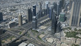 Aerial view of a bustling cityscape with modern skyscrapers, intricate highway interchanges, and urban greenery, showcasing a vibrant metropolitan area. - Powered by Shutterstock - Get 15% off with code: PIKWIZARD15