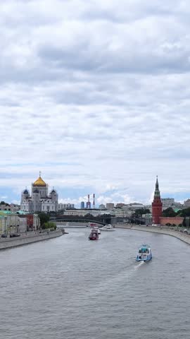 Panoramic view of Moscow city center and Moskva river with tour boat. The Red Square, Kremlin towers on background. Urban life travel. 