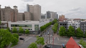 Traffic signal intersection, green trees lined suburban city streets with skyline buildings in background, Peachtree Center, Atlanta, Georgia, Aerial view - Powered by Shutterstock - Get 15% off with code: PIKWIZARD15