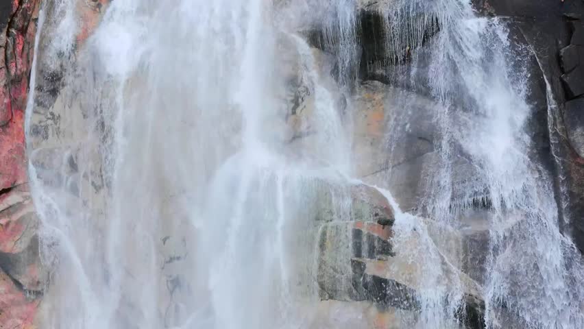 Aerial view of Shannon Falls in Canada, with water rushing down the canyon, surrounded by lush forests and rugged mountain scenery.