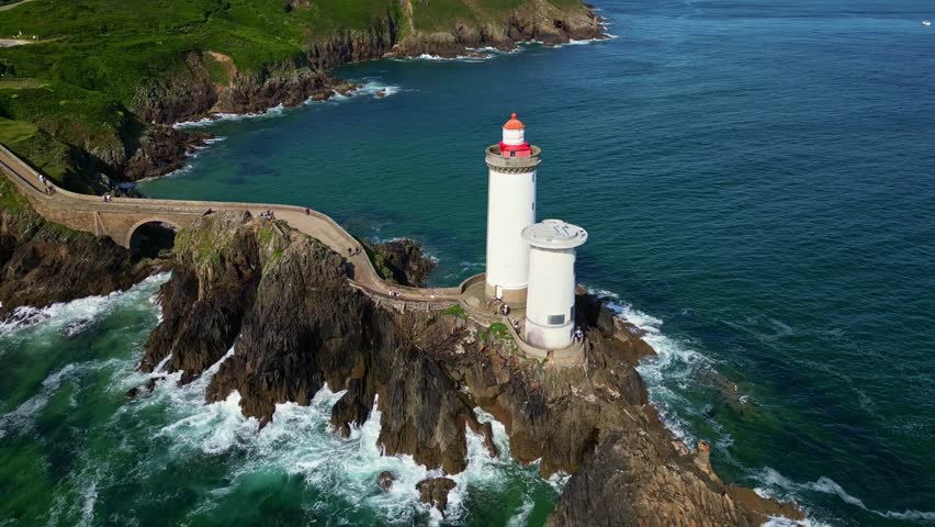 Petit Minou Lighthouse on rocky coast, France. Aerial drone orbiting
