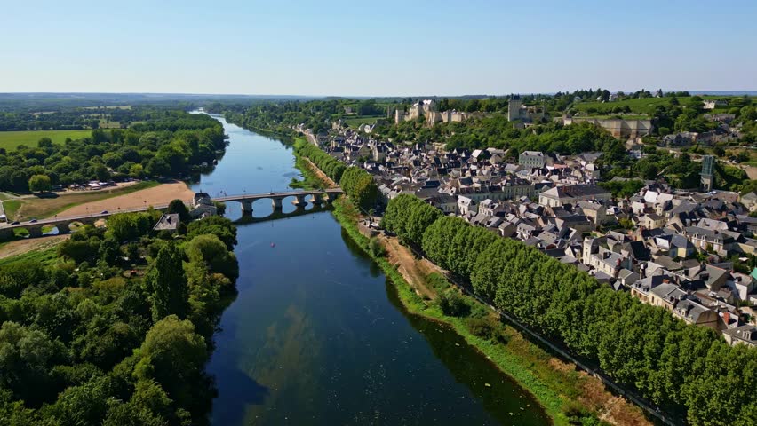 Chinon town and Royal Fortress, historic town on banks of Vienne River with bridge and castle, Loire Valley, France. Aerial forward