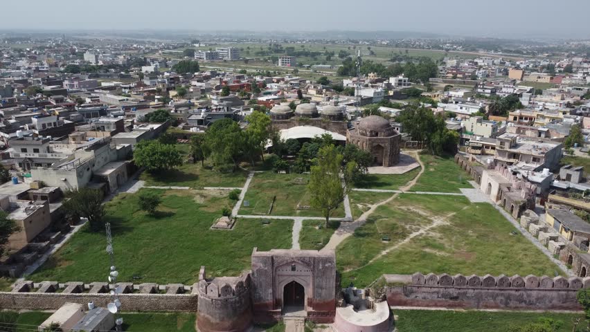 Aerial view of historic Rawat Fort in Pakistan surrounded by rural landscape showing ancient Mughal architecture and heritage