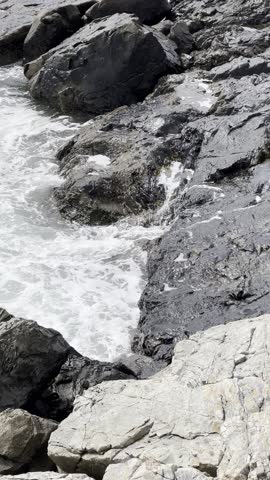 Aerial Top View Looking Down Rocky Cliff Ocean Sea Water Splash Waves Breaking Rocks Coast Thunder Hole Acadia National Park Maine USA