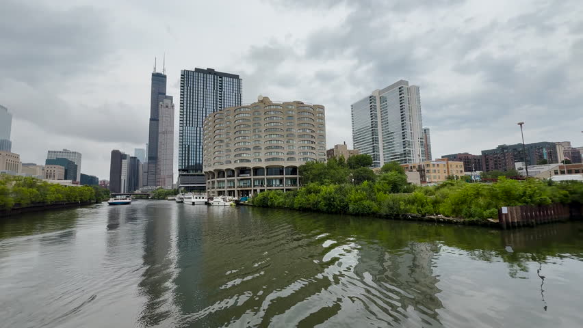 Iconic mid-century modern architecture and skyscraper buildings on the Chicago River. Summer scene with boats on the water. Located on the south bank of the Chicago River in Chicago, Illinois.