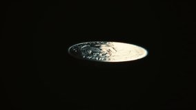 Seamless loop of a United States quarter dollar coin flipping on a dark background, symbolizing gambling, luck, finance, and decision making. - Powered by Shutterstock - Get 15% off with code: PIKWIZARD15
