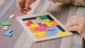 hands carefully placing colorful wooden geometric shapes intellectual puzzle, therapy cognitive training, dementia aid, brain health, occupational therapy, logical thinking, mental exercise concept - Powered by Shutterstock - Get 15% off with code: PIKWIZARD15
