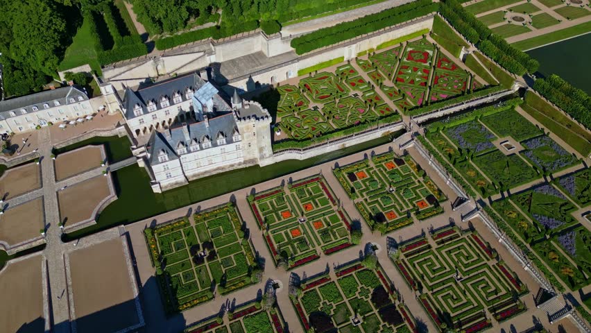 Aerial view of Château de Villandry, Renaissance gardens, castle with moat and manicured formal gardens, Loire Valley, France. Aerial top-down orbiting