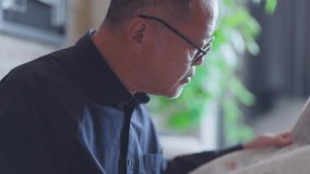 Senior Japanese man reading a newspaper - Powered by Shutterstock - Get 15% off with code: PIKWIZARD15