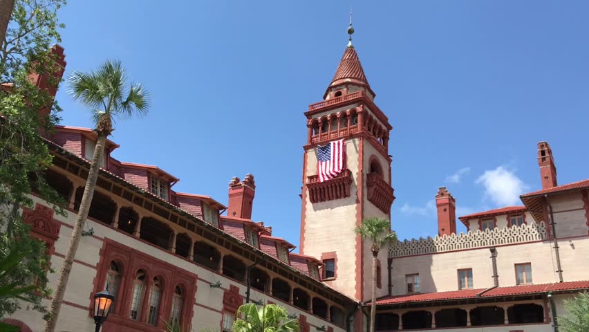 Flagler College, a historic landmark in St. Augustine, Florida, showcases its Spanish colonial architecture and American flag, a popular tourist destination