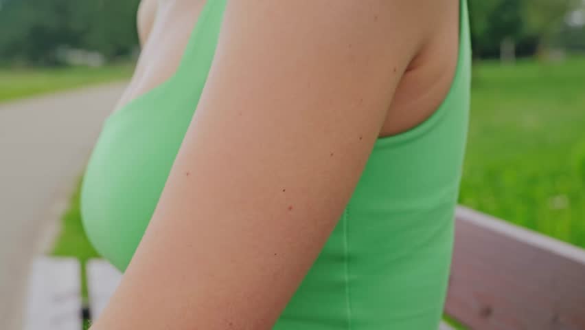 Wireless biosensor patch on woman’s arm, future health data flow technology