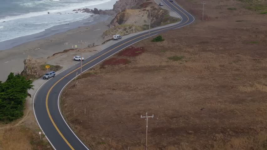 Scenic California coast highway 1 winding along rugged cliffs, peaceful day
